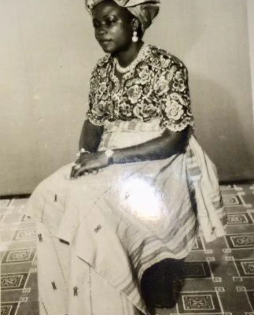 A young Grace Unachukwu seated in lace and wrapper, Lagos